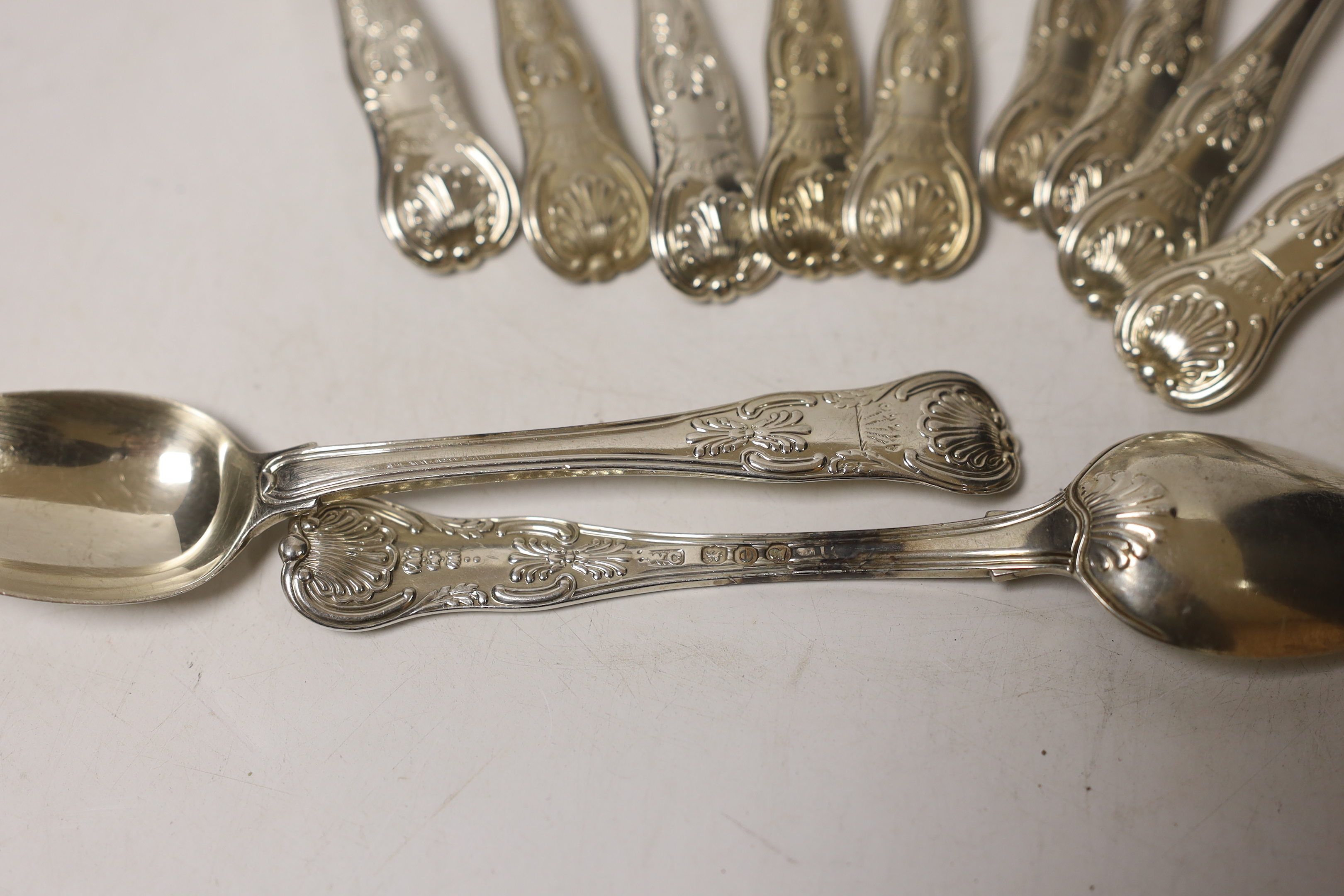 Eleven George IV silver Kings honeysuckle pattern teaspoons, William Chawner II, London, 1820, 12.8oz, with engraved crest.